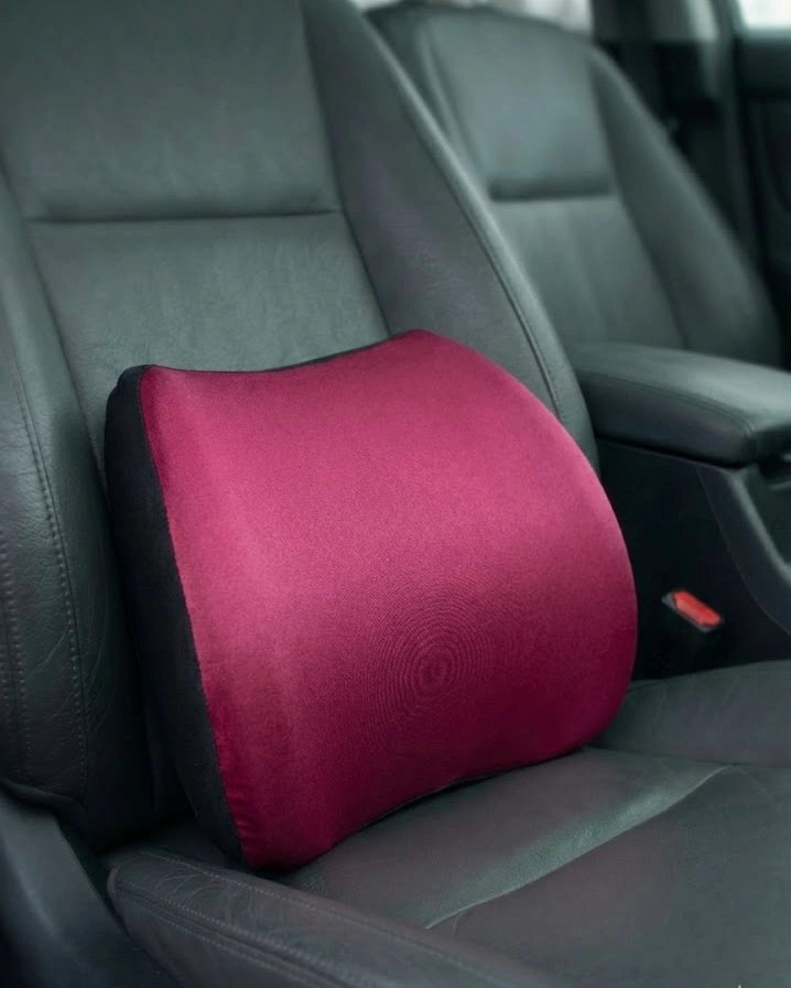 Red memory foam car backrest cushion on driver seat with breathable fabric cover