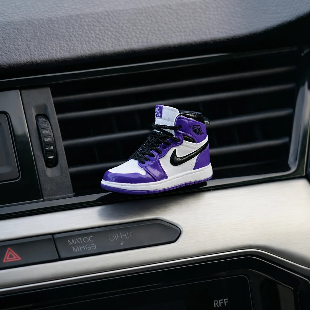 Purple sneaker car air freshener mounted on car dashboard AC vent – refillable vent clip perfume