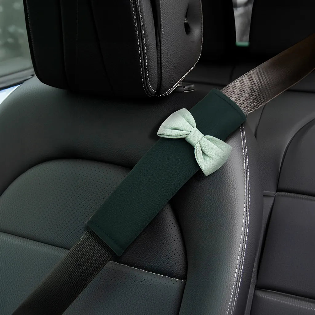 Green car seat belt cover installed on car seat