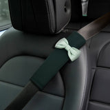 Green car seat belt cover installed on car seat