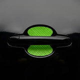 Green carbon fiber door handle scratch guard sticker installed on black car door bowl. A quirky Car-Wah! car accessory statement piece that adds instant personality.