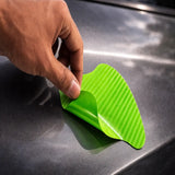 Flexible green TPU carbon fiber door handle sticker being applied to car surface.A fun Car-Wah! car decor upgrade for your daily drives.