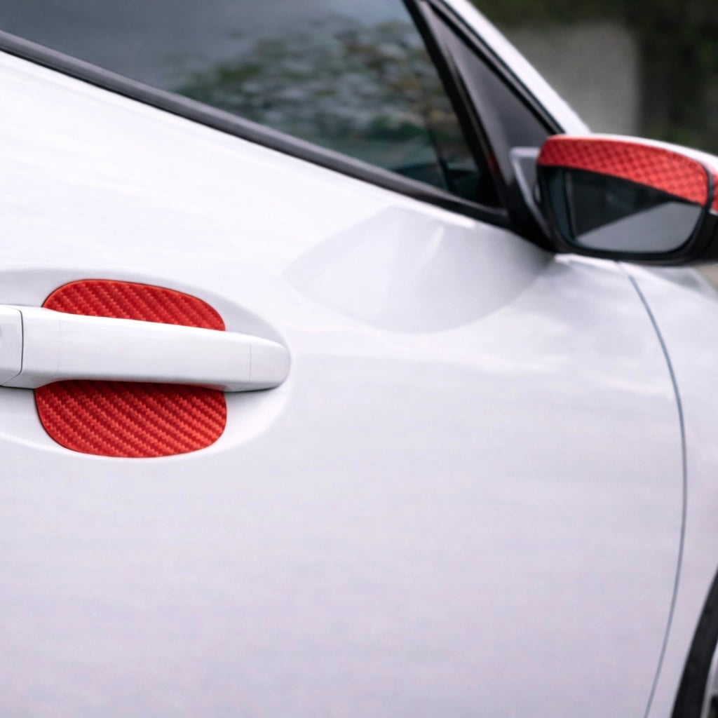 Red carbon fiber door handle scratch guard with matching mirror accent on car exterior. A bold Car-Wah! car accessory upgrade for your daily drives.
