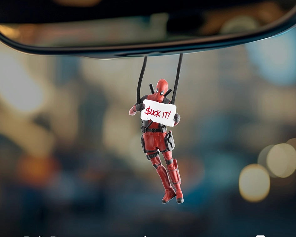 Car-Wah! Anti-Hero car dangler Suck It pose hanging from rear view mirror inside car interior