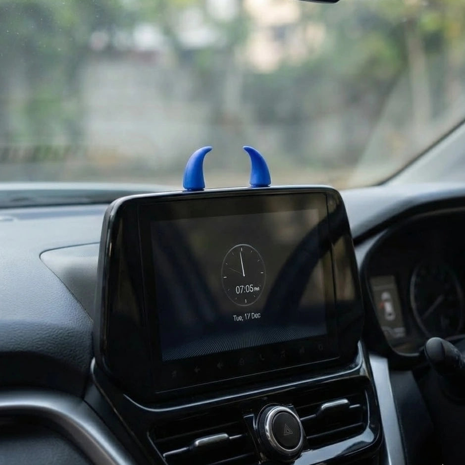 blue devil horn car dashboard decor placed on infotainment screen. Add a bold, unique car accessory to your car interior with Car-Wah!