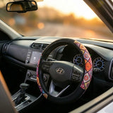 Fabric steering wheel cover installed on car steering wheel during city drive.A unique Car-Wah! car accessories for driving comfort upgrade.