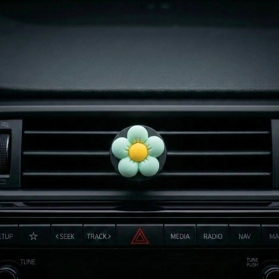 Green flower car air freshener vent clip installed on car AC vent. A fun and fresh Car-Wah! car perfume for your daily commute.