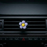 Purple flower car air freshener vent clip attached to car AC vent. A fun and fresh Car-Wah! car perfume for your daily commute.