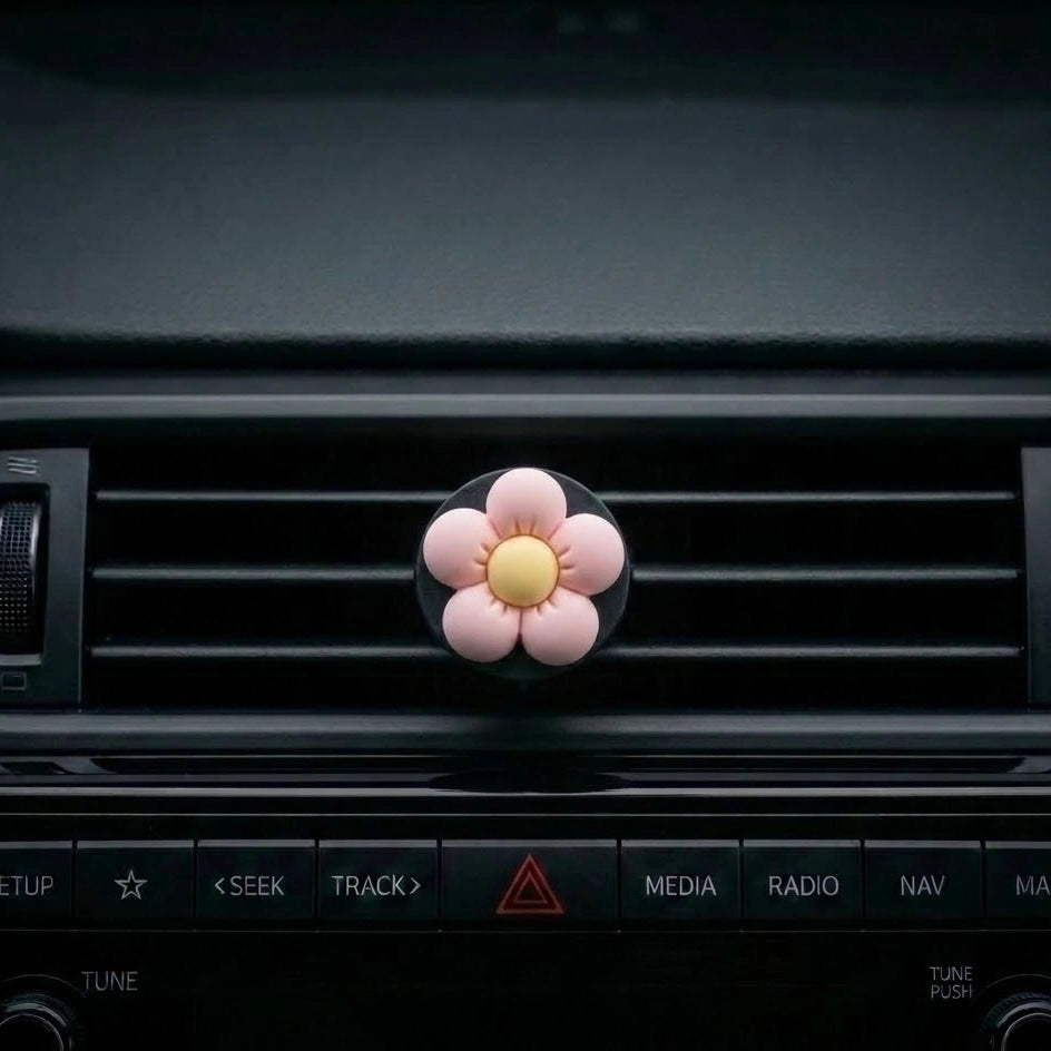Pink flower car air freshener vent clip perfume on car dashboard vent. A fun and fresh Car-Wah! car perfume for your daily commute.