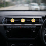 Yellow flower car air freshener vent clip installed on car dashboard vent. A unique Car-Wah! car fragrance to keep your car cabin smelling extraordinary.