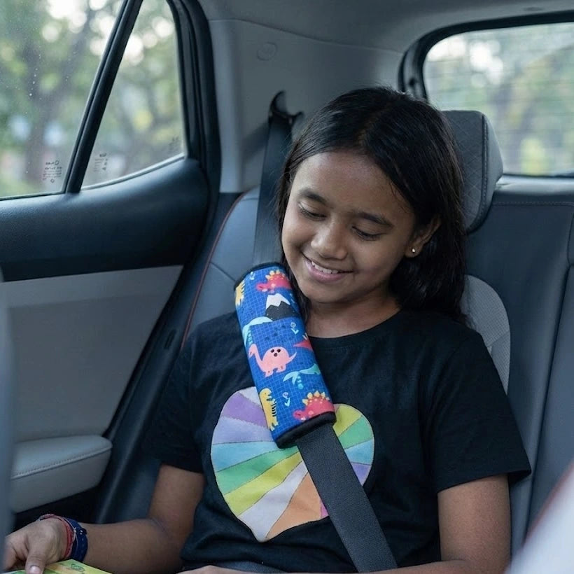 Child wearing blue seat belt cover – prevents seat belt rubbing on neck. Making traffic a little more fun with Car-Wah! comfort car accessories.
