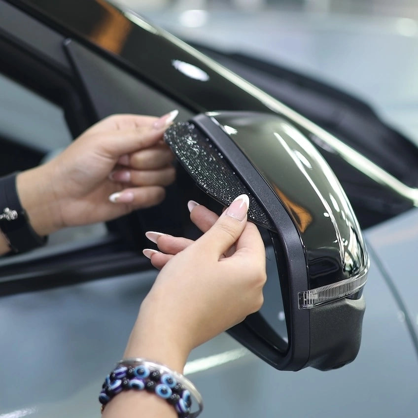 Installing rhinestone car side mirror cover with 3M adhesive backing. A Car-Wah! unique and afforable car accessory.
