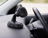 Black bling car phone holder mounted on dashboard. Close-up macro detail of the sparkling crystals on the bling car mobile holder, a playful Car-Wah! statement piece