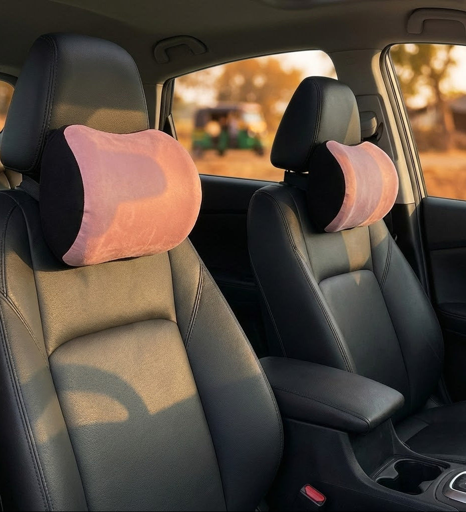 Pink car neck pillow on headrest interior view