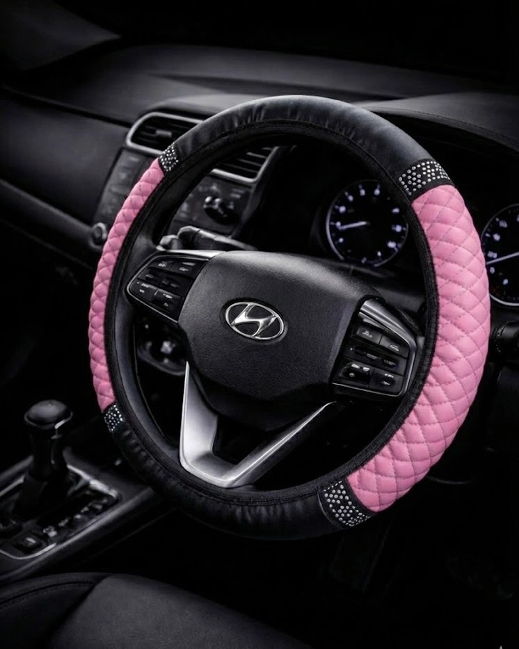Pink PU leather steering wheel cover with anti-slip grip and rhinestone detailing fitted on standard 38 cm steering wheel. A colourful Car-Wah! car decor upgrade for your daily drives.