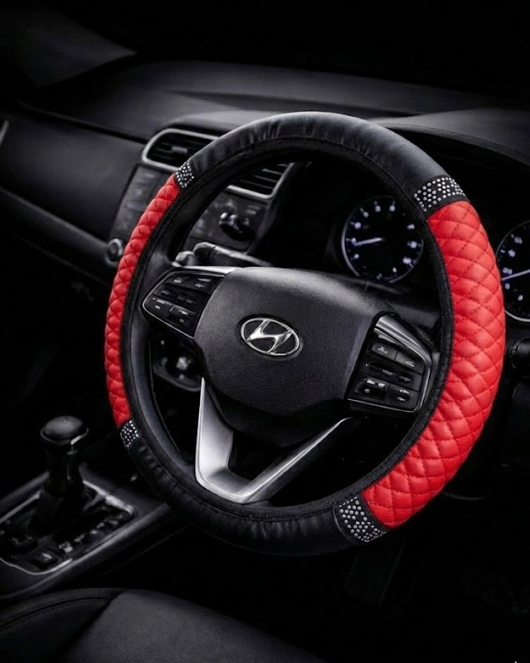 Red PU leather steering wheel cover with anti-slip design and rhinestone grip on 38 cm car steering wheel.  A colourful Car-Wah! car decor upgrade for your daily drives.