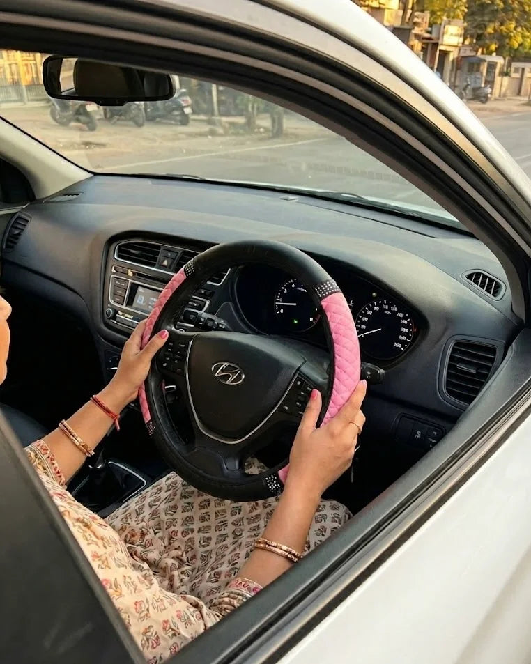 Pink PU leather anti-slip steering wheel cover installed on 38 cm steering wheel for better comfort and control. A premium Car-Wah! car accessory to show off your ride's personality.
