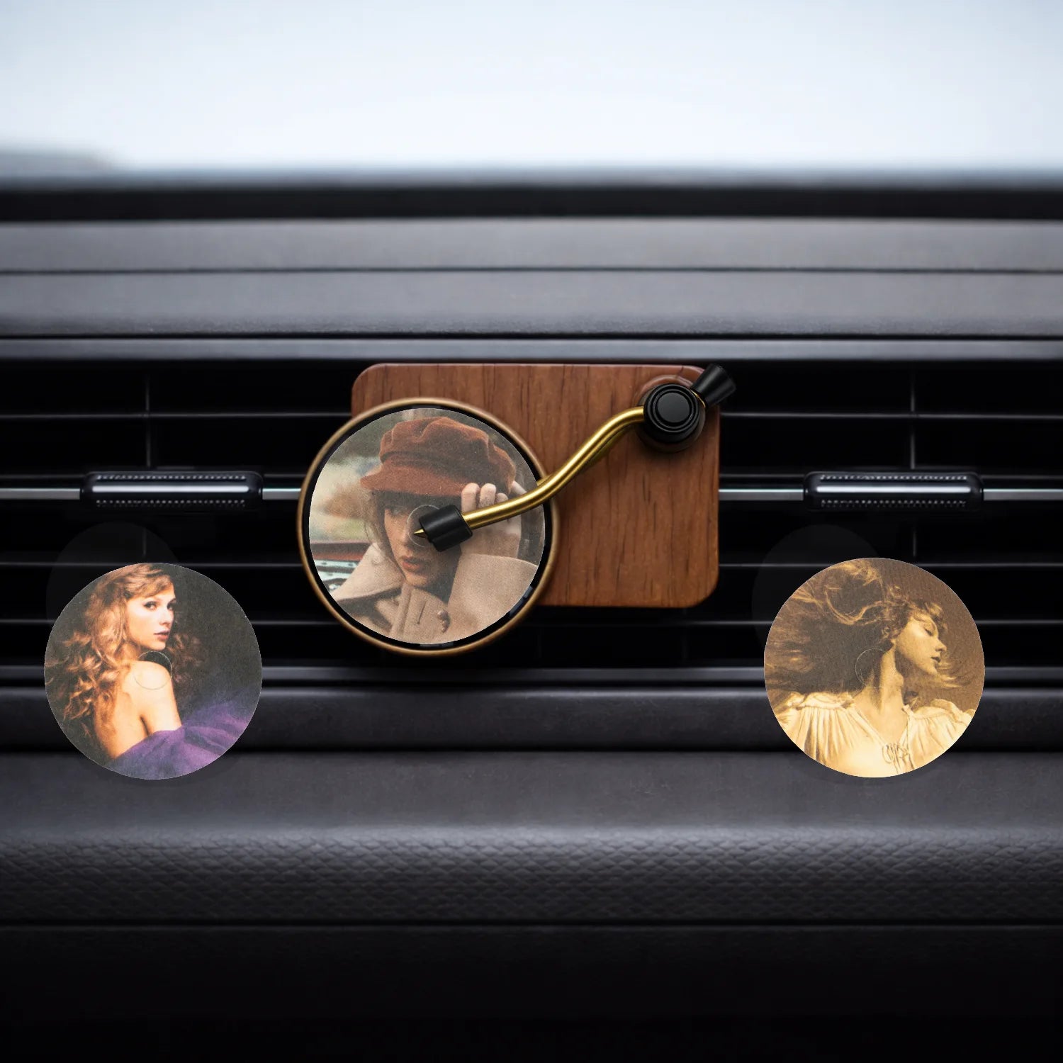 Record Player Car Air Freshener with Fearless, Speak Now and Red perfume discs clipped to car AC vent. A unique Car-Wah! car perfume to keep your cabin smelling fresh. 