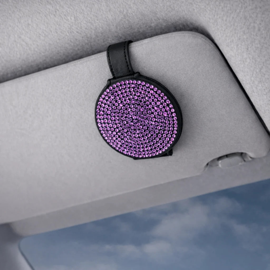 Purple bling sunglasses holder clipped to car visor. A practical and aesthetic car accessory by  Car-Wah! to keep your world on wheels organized.