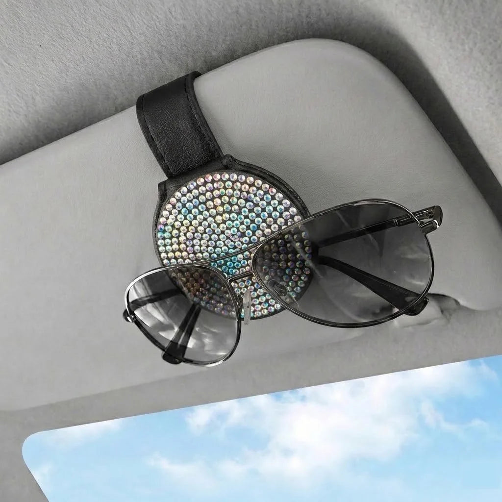Polychrome rhinestone sunglasses holder clipped to car visor holding sunglasses. Affordable and unique Car-Wah! car storage for your daily commute.