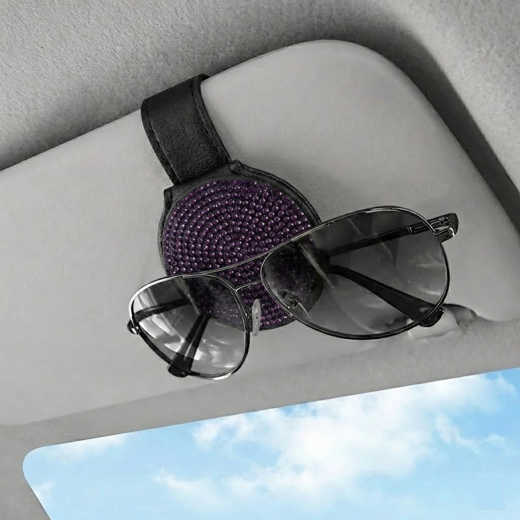 Purple bling visor clip sunglasses holder holding sunglasses. Affordable and unique Car-Wah! car storage for your daily commute.