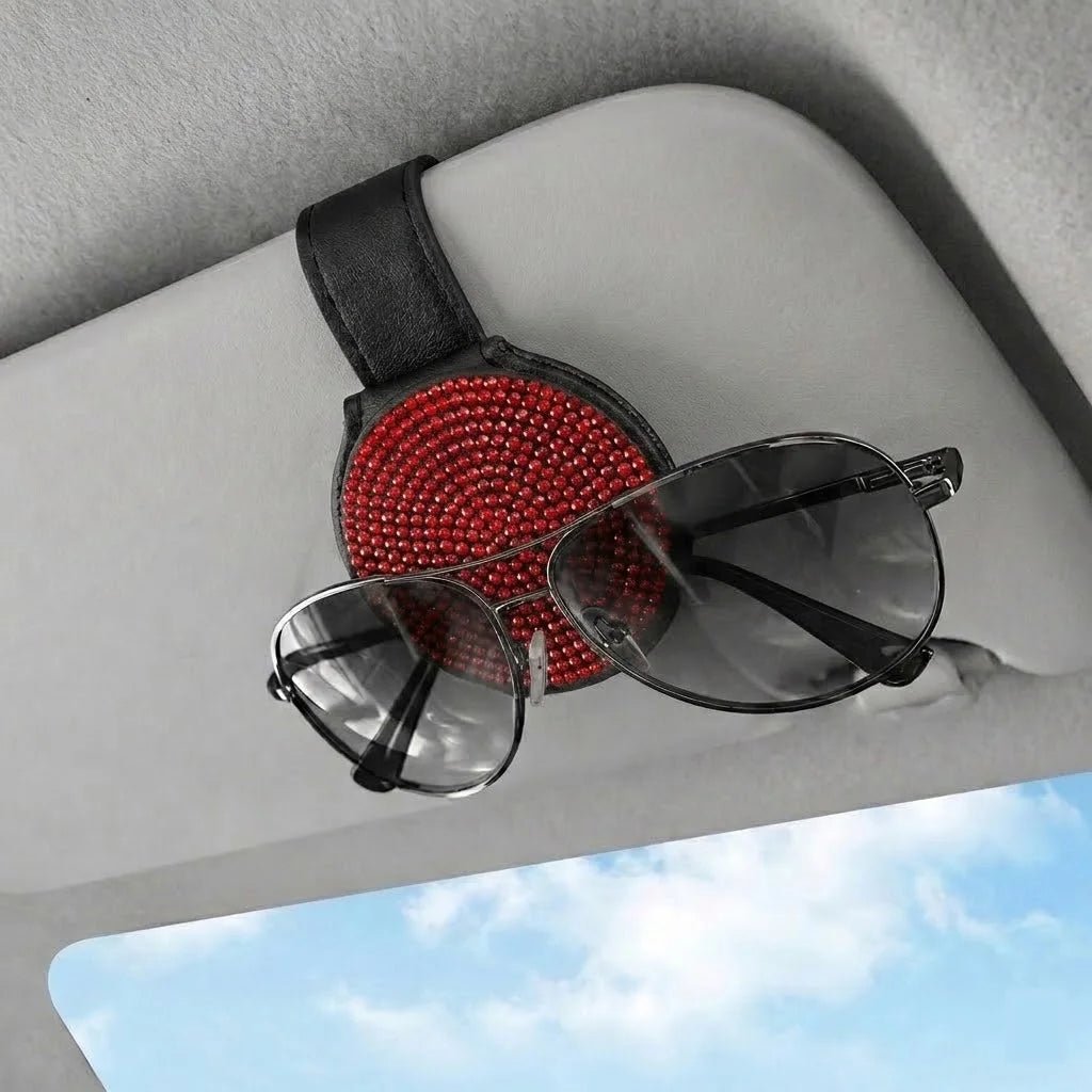Red magnetic sunglasses holder on car visor holding sunglasses. Affordable and unique Car-Wah! car storage for your daily commute.