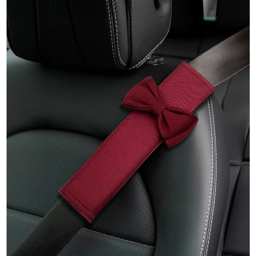 Red car seat belt cover installed on driver seat showing neck comfort. A colourful and cozy driving comfort car accessories by Car-Wah!