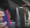 Person aligning ORVM cover onto car side mirror for stick-on installation, Pressing rhinestone ORVM cover firmly onto side mirror to secure adhesive