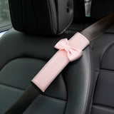 Pink car seat belt cover installed on passenger seat